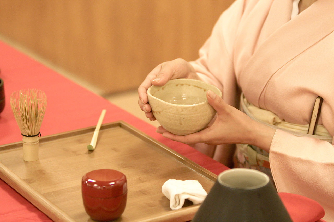 tea being served with two hands by tea master