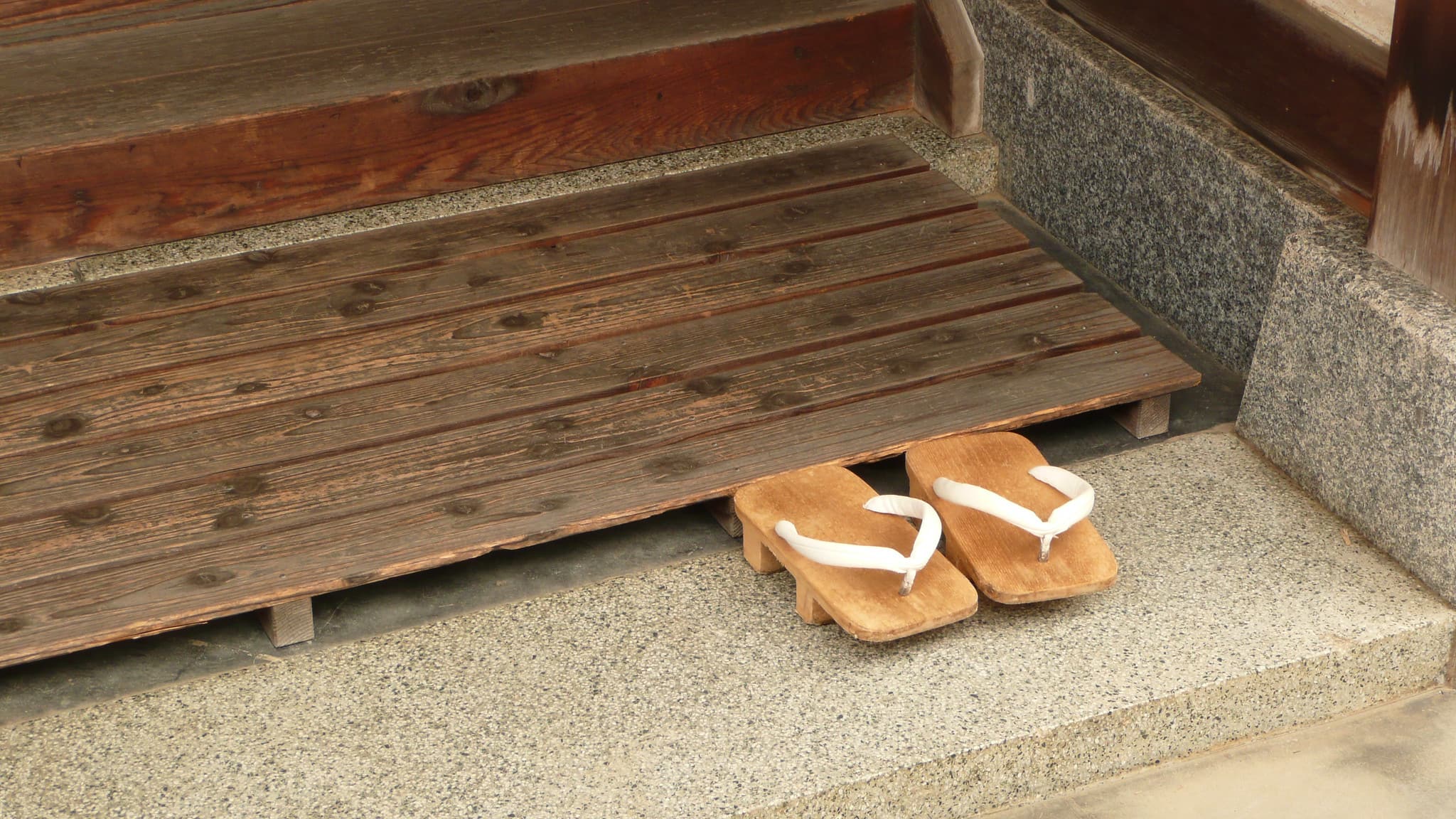 a pair of slippers for guests at a doorstep in japan