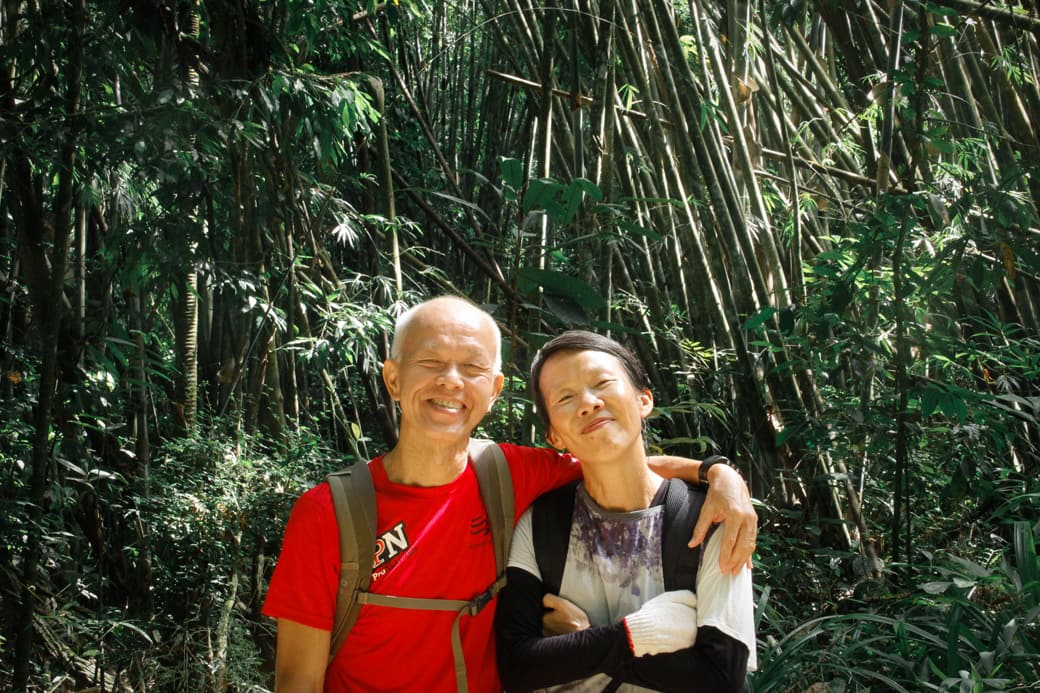 Parents posing among bamboo trees in Khao Sok National Park