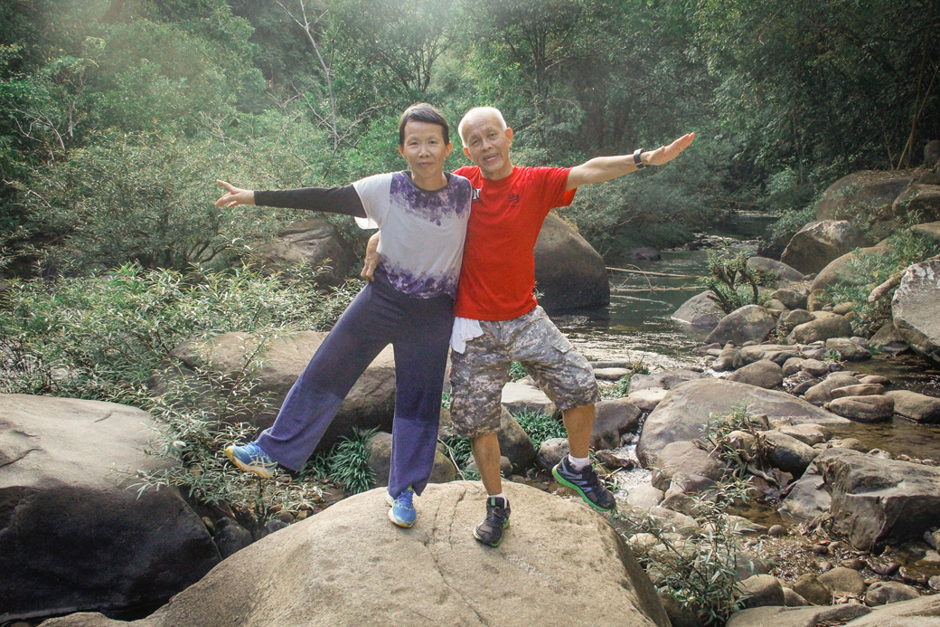 Parents posing on a hiking trail in Khao Sok National Park