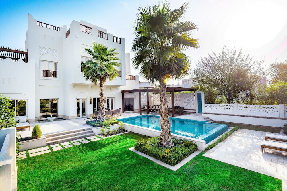 white building outdoor pool palm trees