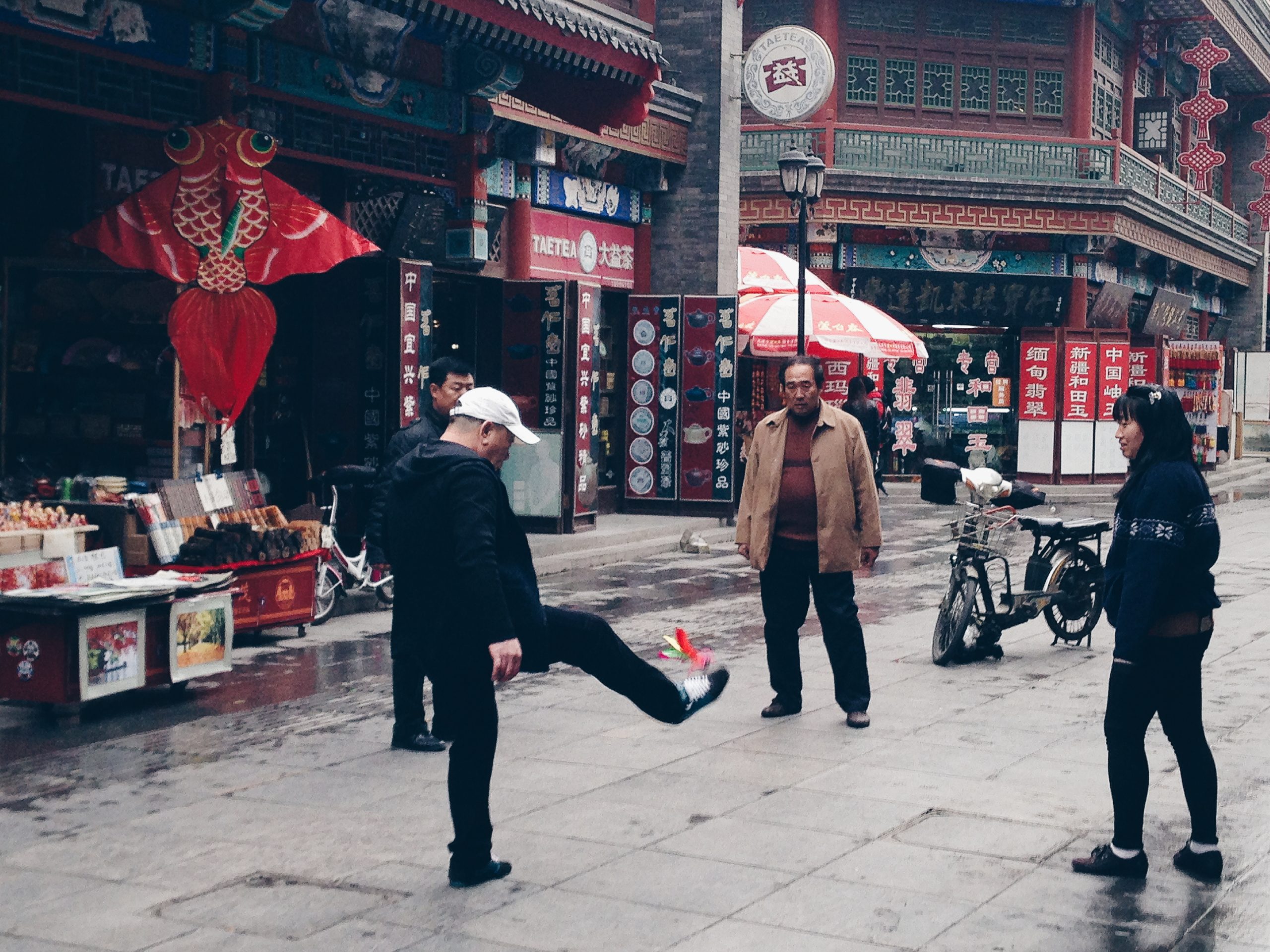 A friendly game of jianzi on Ancient Cultural Street