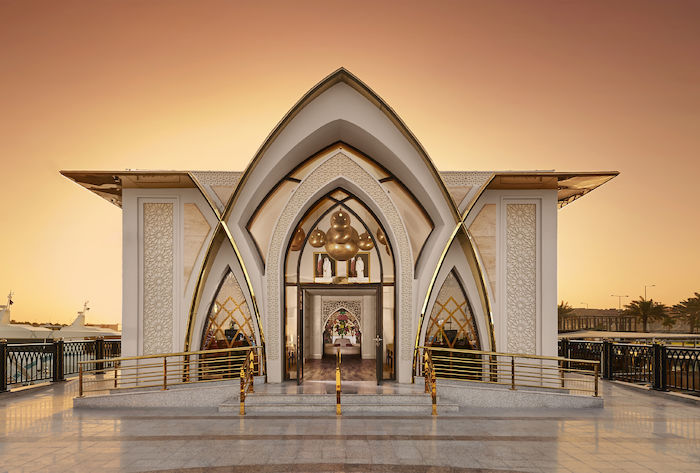 white hotel facade with gold accent