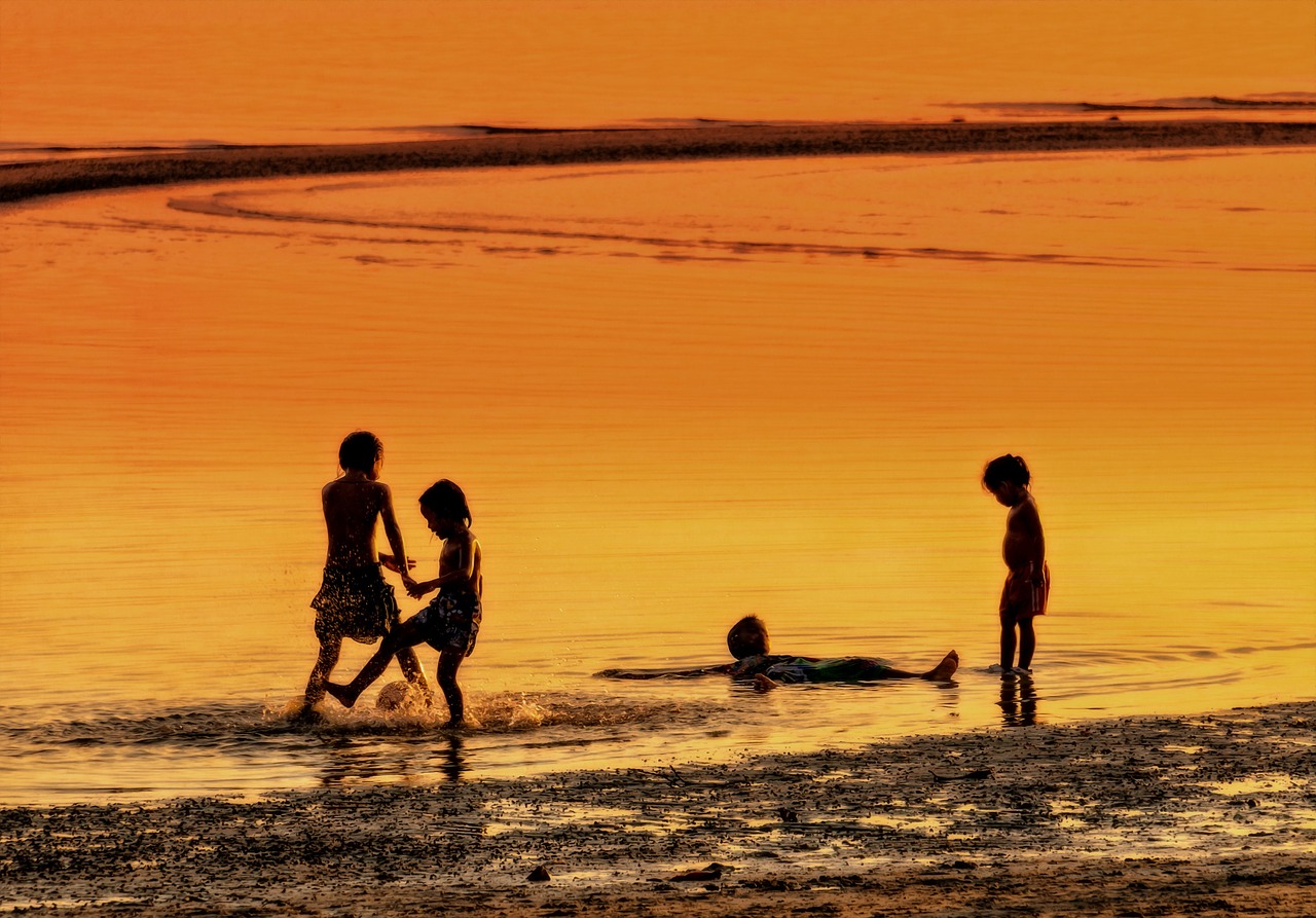 kids playing beach at sunset koh samui