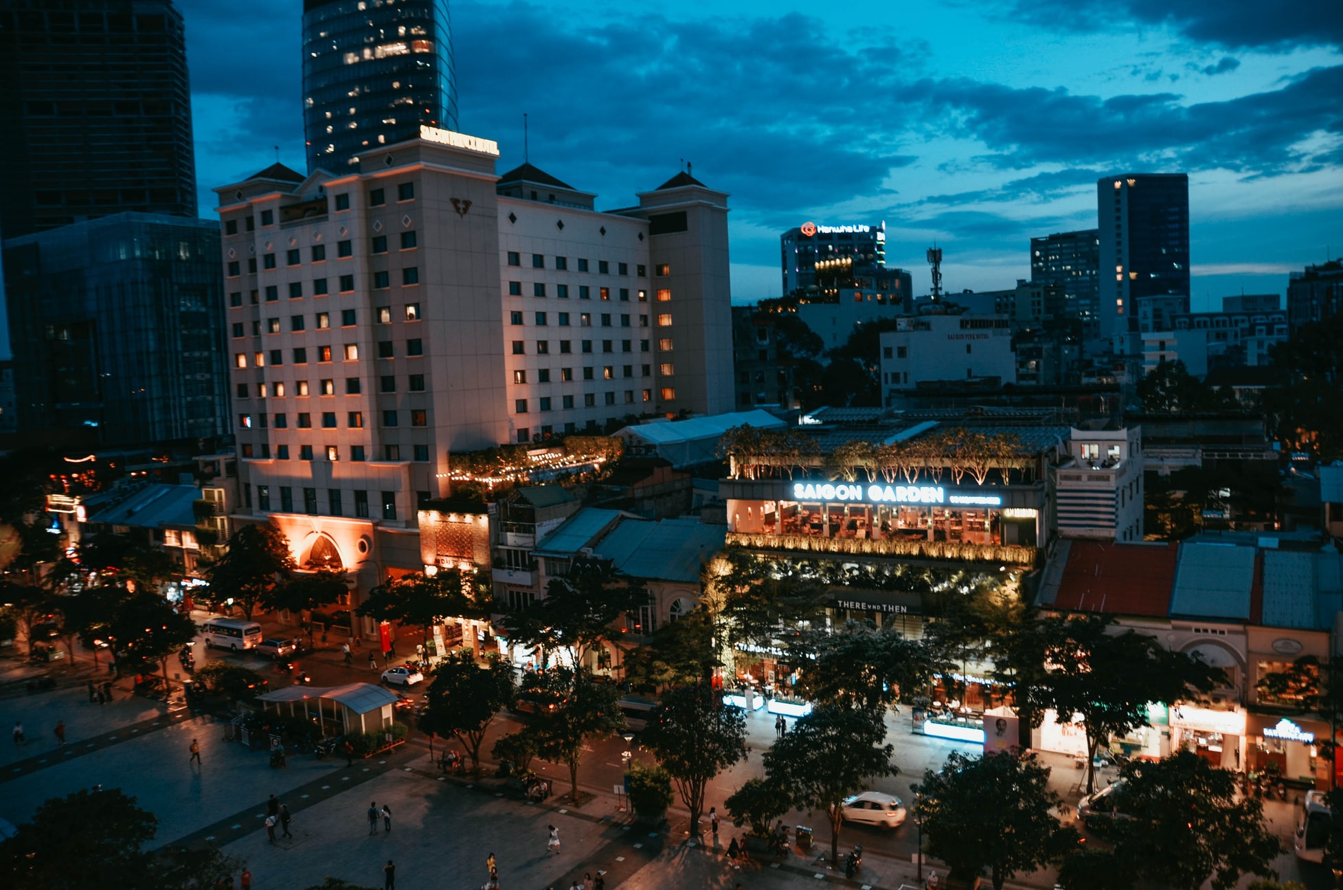 street with buildings and lights at night ho chi minh