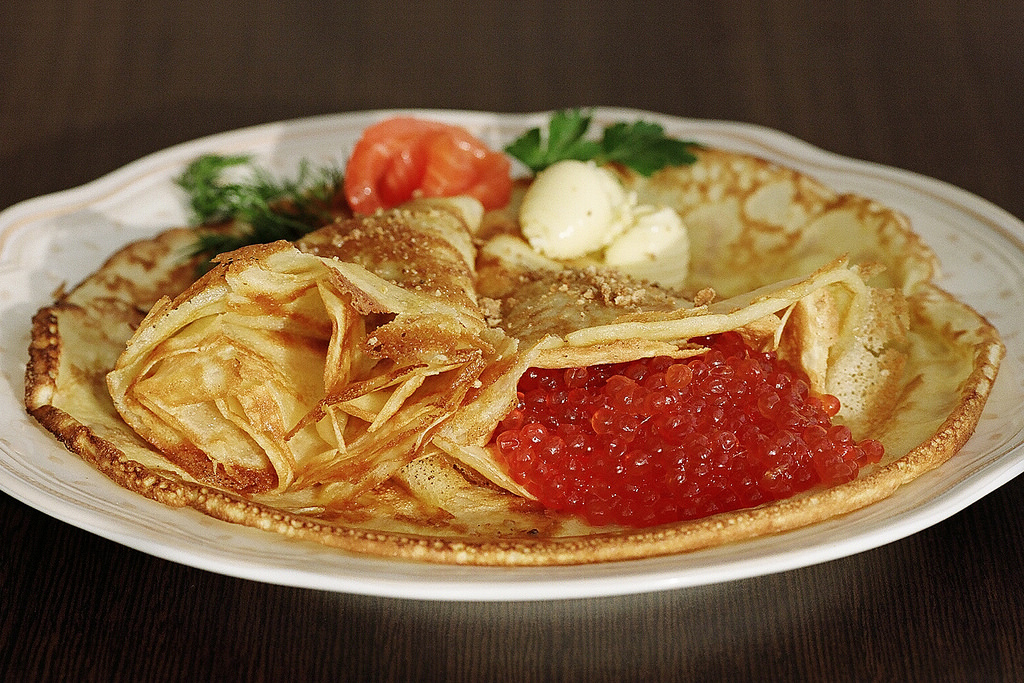 Russian pancakes with caviar and sour cream