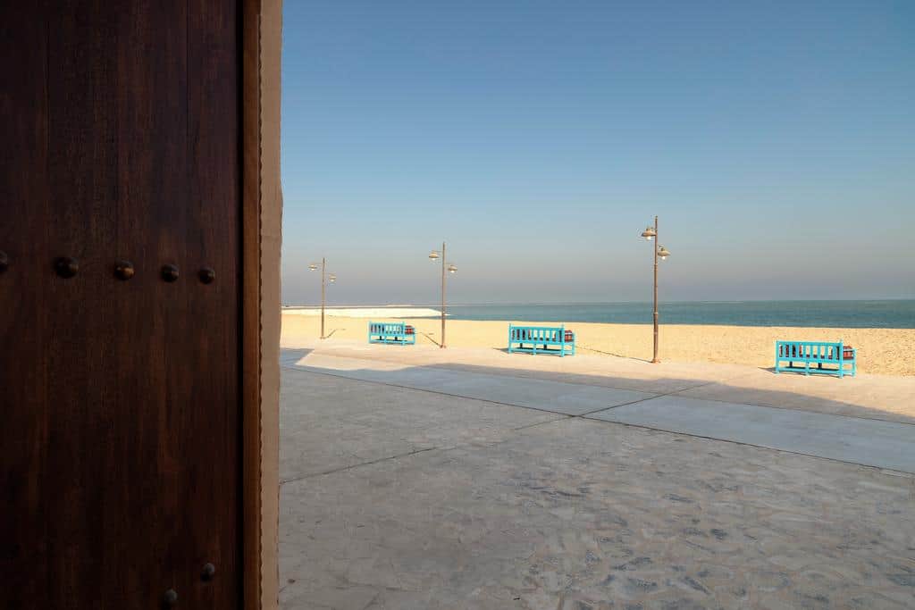 beach side with blue benches
