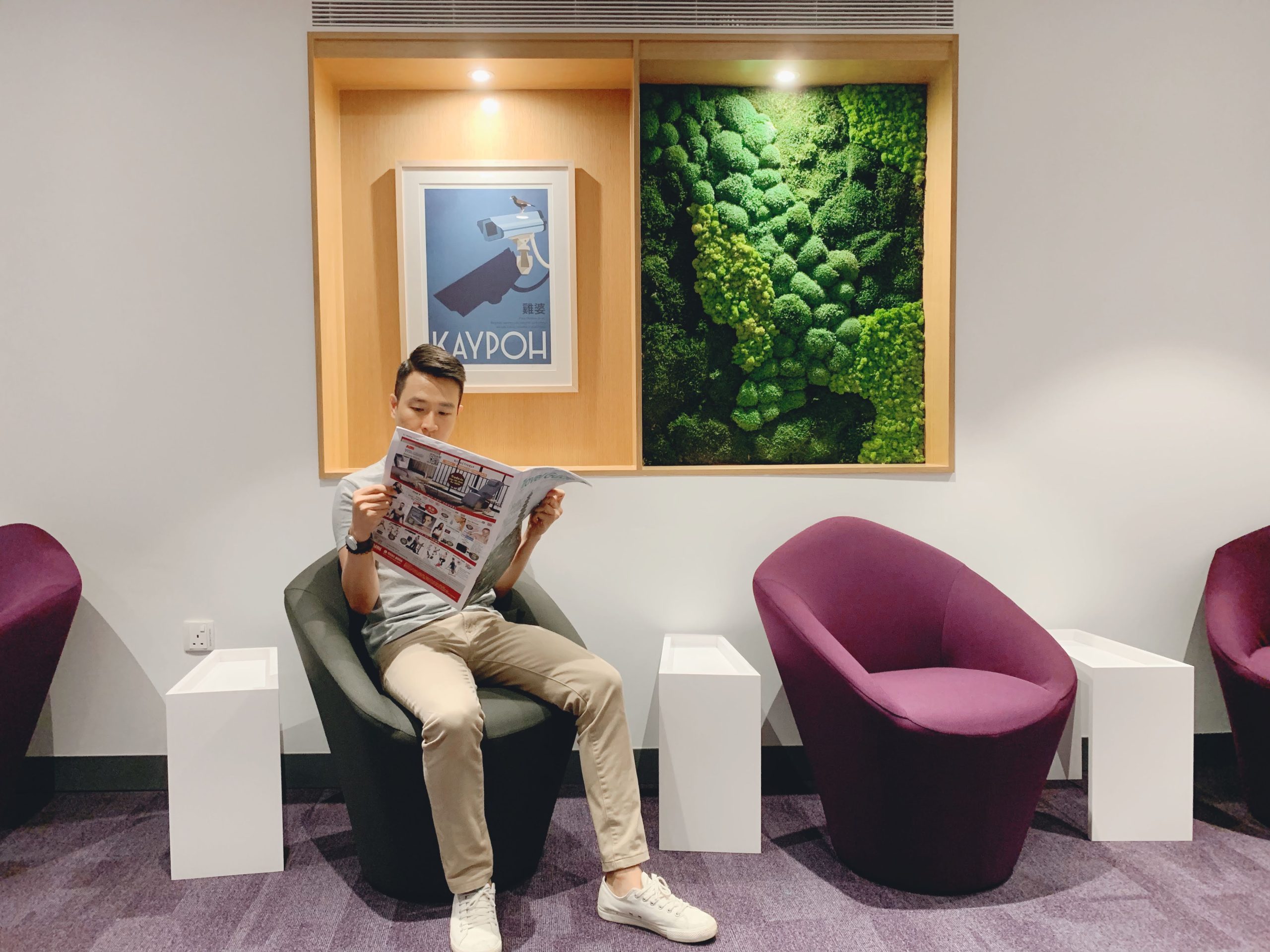 Reading a newspaper at KOMYUNITI, YotelAir