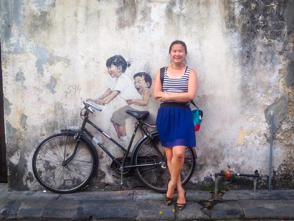Writer posing with penang street art